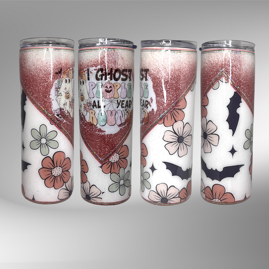 20oz stainless steel tumbler showing four sides. Design has v split, bottom shows retro flowers, bats an diamond  shapes. Top half shows ombre glitter colors that match the bottom with a cute ghost holding a pumpkin basket and a quote "I Ghost People All Year Round"