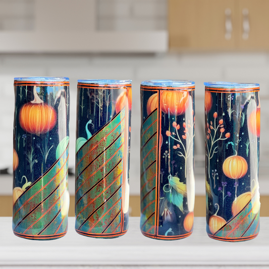 Tumbler sitting on the kitchen counter, the image shows four sides of the tumbler.  Displaying pumpkins, greenery, leaves and branches with black background on one half of the tumbler while the other half shows green and orange rustic look with pin stripes in oranges and blacks. The tumbler comes with lid and straw.