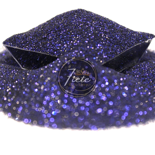 A pile of fine-cut navy blue glitter overflowing from a small clear container and the 'Siete Gift Shop' logo displayed prominently.