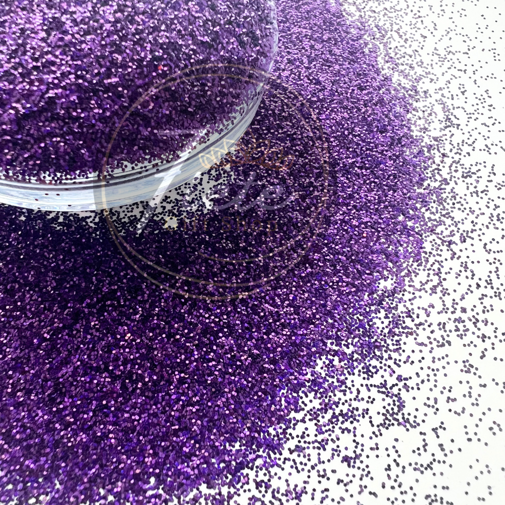 loose purple fine glitter in a bowl and some on the flat surface 