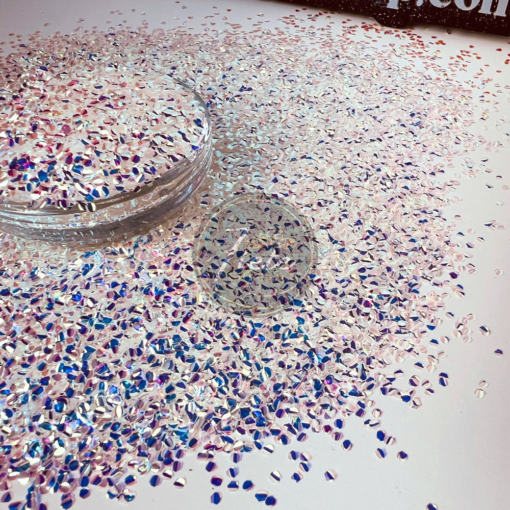 Bowl full of loose dragon scales, white with a shift of blue. The scales are surrounding the bowl on a flat white surface.